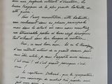 a handwritten letter on a piece of paper on a table