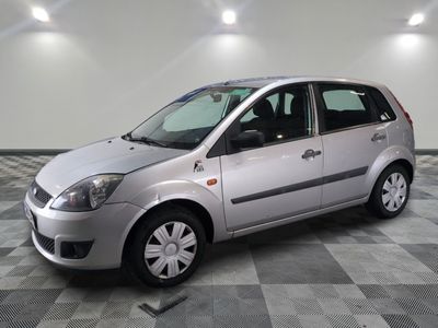 a picture of a small silver car parked in a garage
