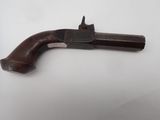 an old gun with a wooden handle on a white surface