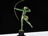 a bronze statue of a woman with a bow and arrow