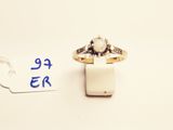 a small ring with a stone in it and a price tag