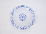 a blue and white plate sitting on a white table
