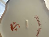 a white plate with red writing on it on a table