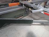 a machine that is cutting a piece of wood