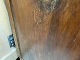 a wooden cabinet with a metal latch on the door