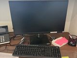 a computer desk with a keyboard, mouse, and monitor