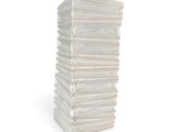 a tall stack of white paper bags on a stick