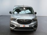 the front view of a silver car in a showroom
