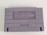 an old nintendo game console sitting on top of a white table