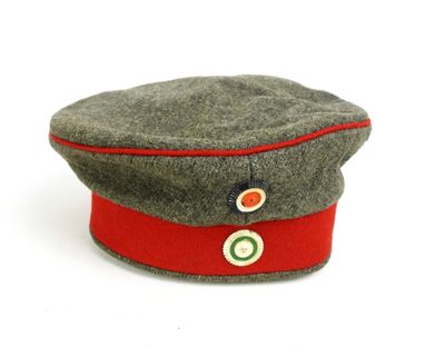 un chapeau orné d'un ruban rouge sur un fond blanc