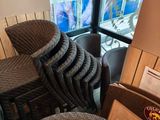 a stack of chairs and a table in front of a window