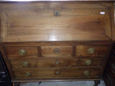 a wooden dresser with brass knobs on it