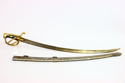 pair of gold plated swords with a curved blade on a white background