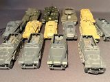 a lot of toy army vehicles that are on a table