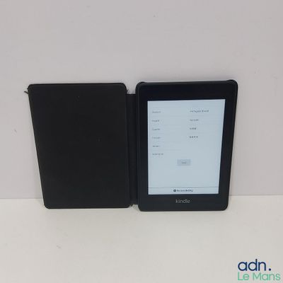 the kindle is sitting next to the black case on the table
