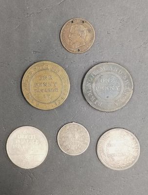 six different coins are shown on a gray surface
