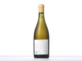 a bottle of white wine sitting on top of a table