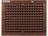 an old wooden vent registerer with six rows of holes on it