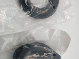 two doughnuts in plastic bags on a table