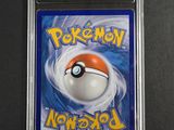 a close up of a pokemon card on a black surface