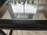 a glass table with a glass top on a wooden floor