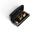 gold cufflinks in a black box on a white surface
