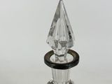 a close up of a glass perfume bottle on a white surface