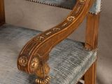 a wooden rocking chair with a blue upholstered seat