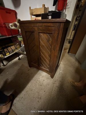 a small wooden cabinet in the corner of a room