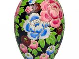a black vase with a colorful floral design on it