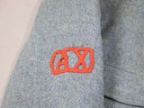 an image of a close up of a shirt with an ax logo on it