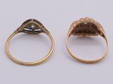 two gold rings with a black stone in the middle of them