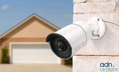 an image of a security camera mounted on the side of a brick wall