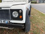 a white land rover parked on the side of the road