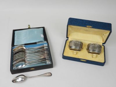 two silver spoons and two silver cups in a box