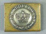 a close up of a metal belt buckle with a crown on it