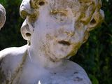 a statue of a boy holding a bird in his hand