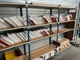a lot of files on the shelves in the room