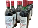 six bouteilles de vin sont alignées sur un fond blanc