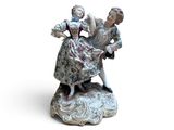 a figurine of a woman and a child on a rock