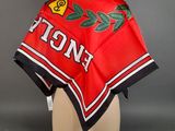 a close up of a red and black scarf on a mannequin head