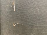 a close up of a piece of wood with peeling paint on it