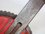a close up of a knife on top of a red object