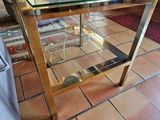 a glass table with a vase on it in a living room
