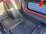 the interior of a car with red trims and a black floor mat