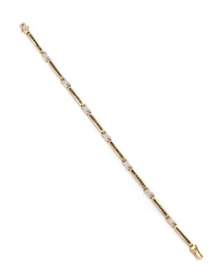 a gold and diamond bracelet on a white background