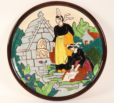 a plate with a painting of a woman and a man