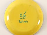 a yellow frisbee with a blue writing on it