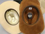 two hats that are sitting next to each other on a table