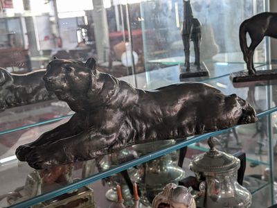 a glass case with a statue of a dog on it